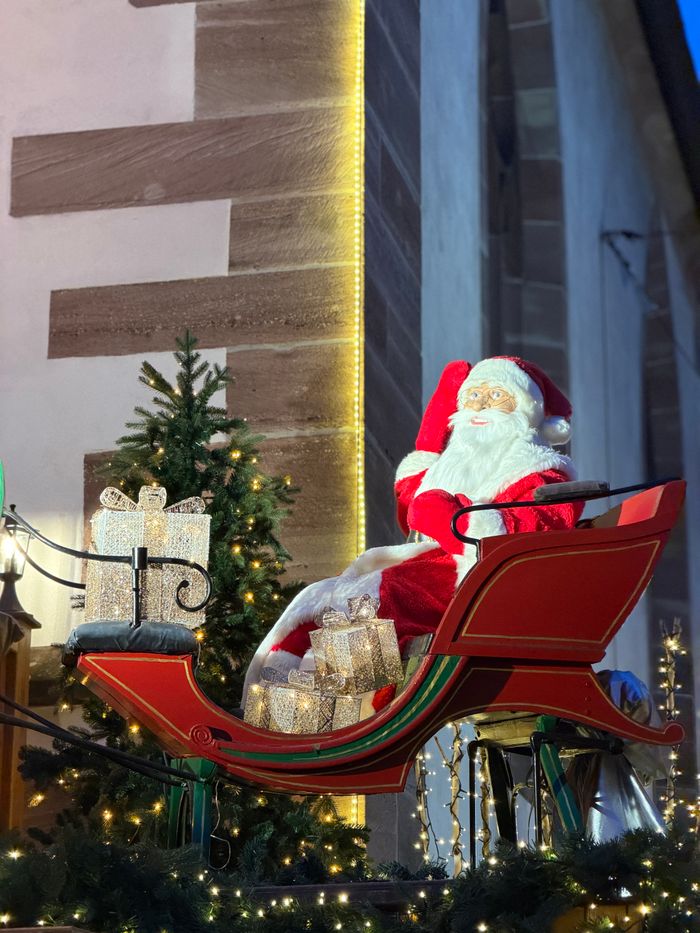 Santa Claus in a sleigh with presents, festive outdoor holiday scene.